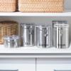 imageOggi Stainless Steel Coffee Canister 62 fl oz  Airtight Clamp Lid Clear SeeThru Top  Ideal for Coffee Bean Storage Ground Coffee Storage Kitchen Storage Pantry Storage Large Size 5quot x 75quotStainless Steel